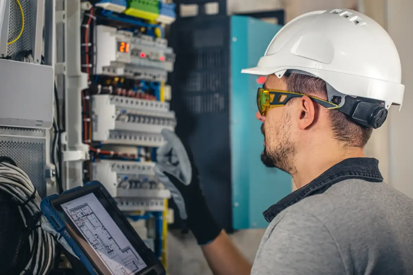 Electrician working inside an electrical panel
